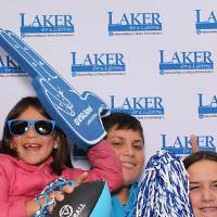 family of four posing together with GVSU merch